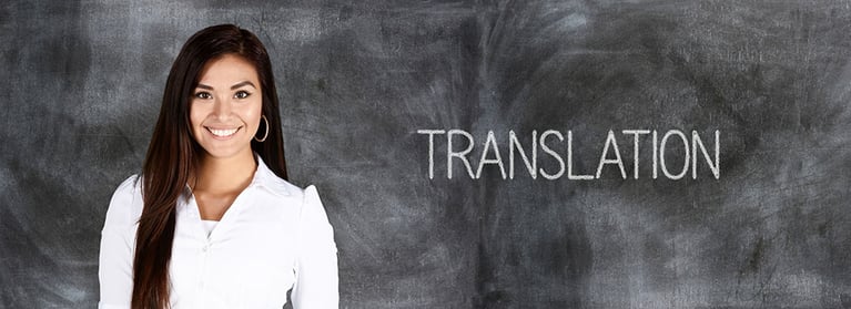 woman standing in front of blackboard that says "translation"