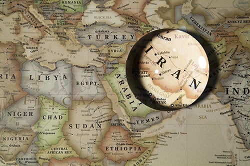 map of the middle east with magnifying glass on Iran 